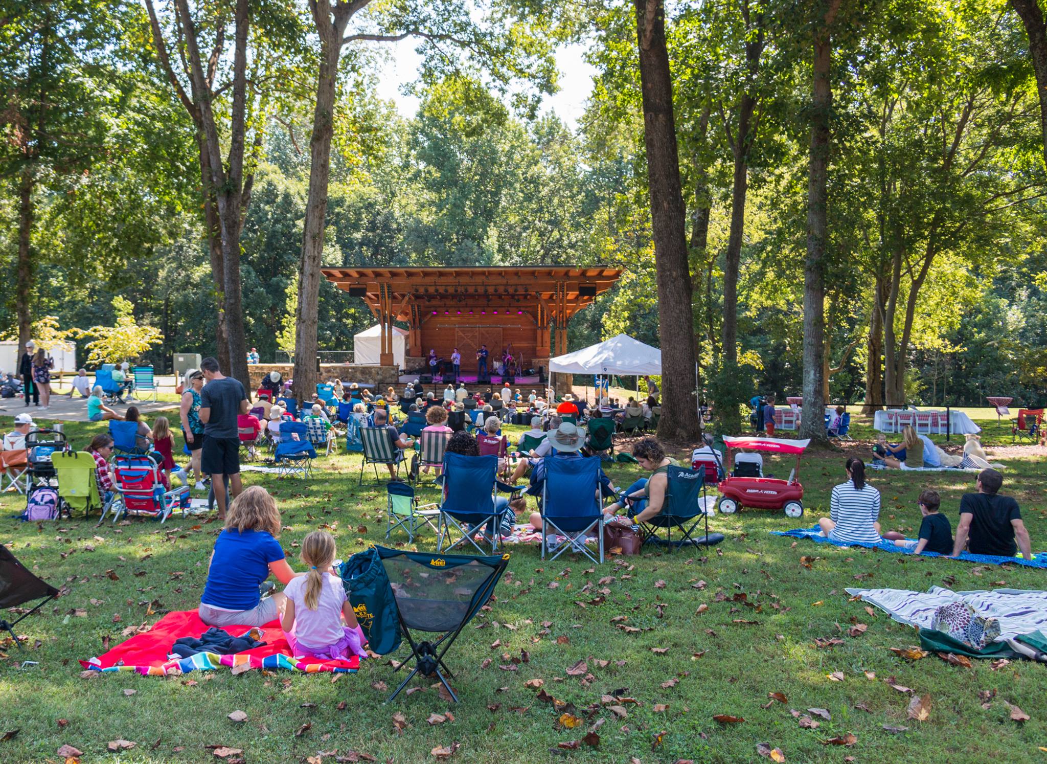 alt=Photo of guests sitting on the lawn of the Summer Concert Series